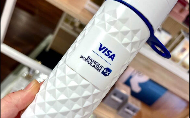 Sustainable travel solutions with JOINTHEPIPE displayed on a stylish white water bottle featuring Visa branding.