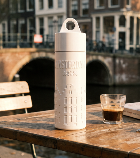 Join the Pipe Amsterdam reusable sugarcane water bottle on a canal-side cafe terrace at golden hour